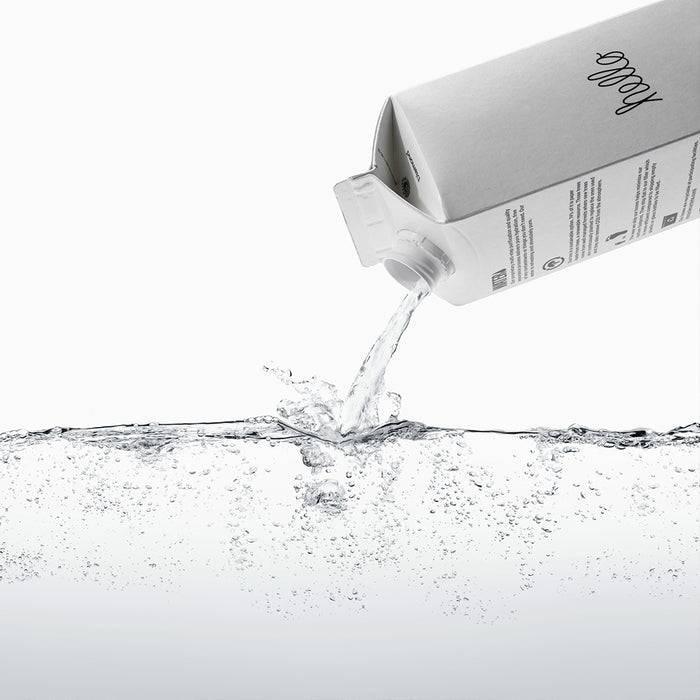 Boxed Water being poured into glass of water
