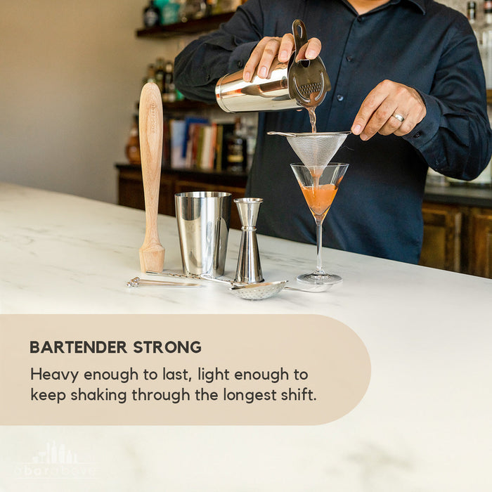 Feature graphic highlighting the strength of the 14-Piece Bartender Kit, with a bartender using silver tools to strain a cocktail (details in description).