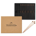 A dozen antique copper cocktail picks with spherical tops, displayed in their packaging and three loose.