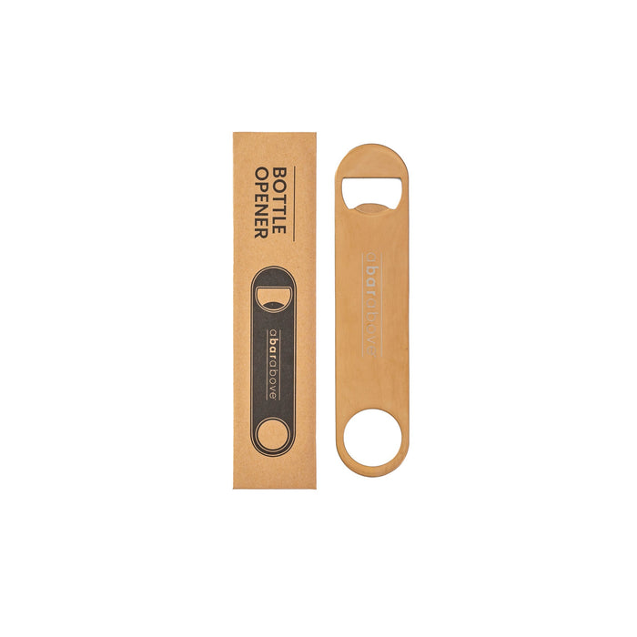 An antique copper bar blade bottle opener displayed next to its branded brown cardboard packaging.