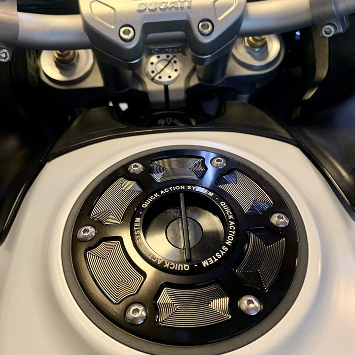 Ducati Hypermotard 950 SP fuel cap by MC Motoparts, engraved with logo, keyless design, black finish, mounted on motorcycle.