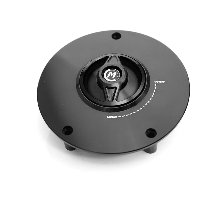 Black CNC quick lock fuel cap for Honda CBF600, VFR1200, CB1000R by MC Motoparts, with a sleek metal finish and locking mechanism.