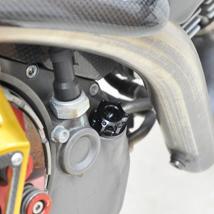 Black CNC oil filler cap for Honda CBR1000RR, CBR600F, and CBR600RR motorcycle by MC Motoparts, shown installed on engine.