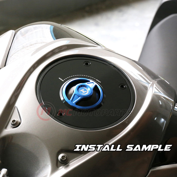 Blue CNC quick lock fuel cap for Suzuki GSX-R1000 and GSXR750, installed on a motorcycle, by MC Motoparts.