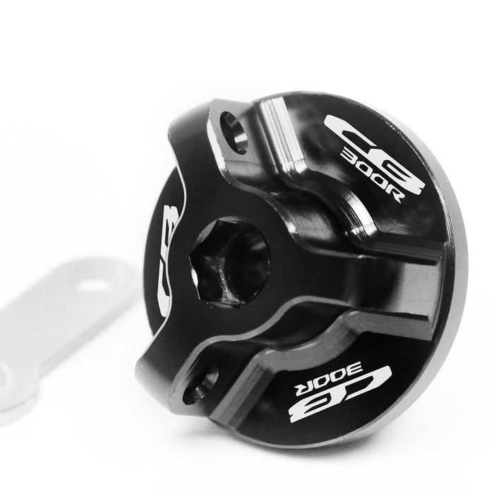 Black engraved oil filler cap for Honda CB300R 2012-2024 by MC Motoparts, featuring logo engraving on metal cap.