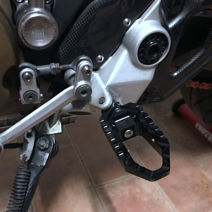 Black Ducati motorcycle touring foot pegs by MC Motoparts, designed for Ducati 1098, 1198, Scrambler, and TRC models.