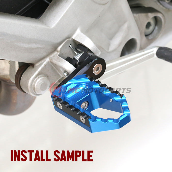 MC Motoparts touring 40mm extension foot pegs for Ducati Monster 1200 821 695 TRC, wide multi-step design, front view.