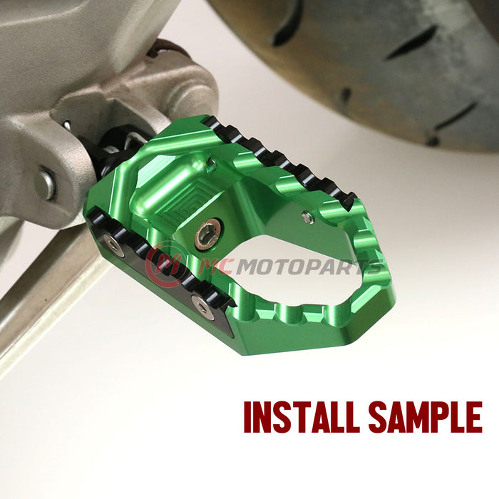 MC Motoparts touring wide foot pegs for Kawasaki Ninja 300R and 650R, shown installed on motorcycle for comfortable riding.