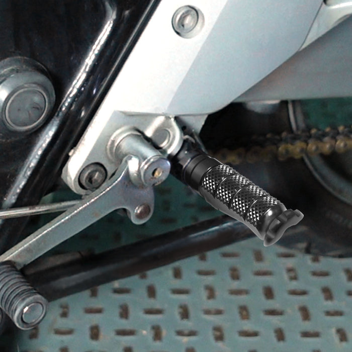 Front view of MC Motoparts R-FIGHT standard foot pegs installed on a Suzuki GSX-R motorcycle, showing black metal design.