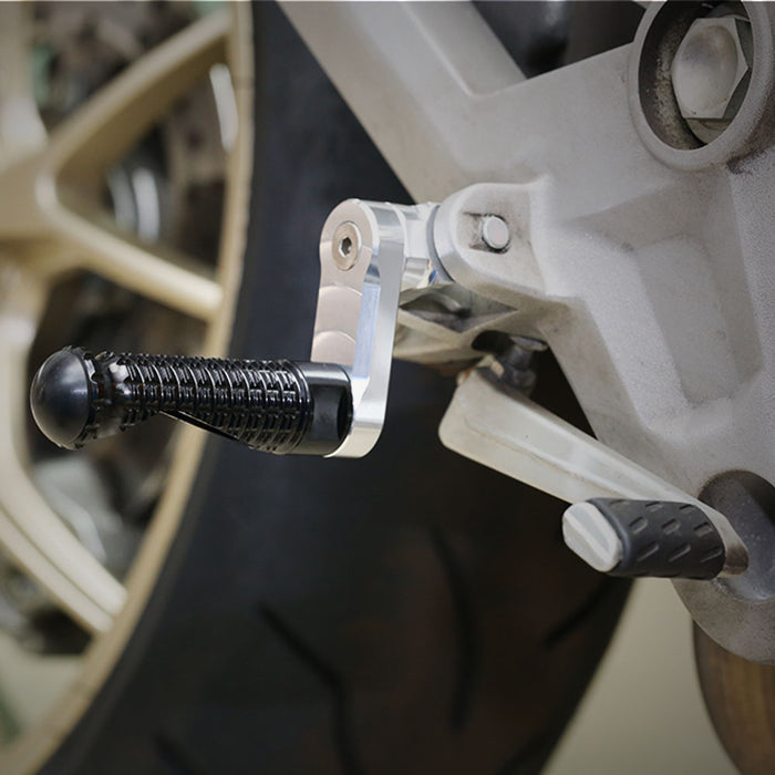 Black 40mm adjustable front foot pegs for Yamaha YZF R6, R3, R1, R125, R25, by MC Motoparts, mounted on motorcycle.