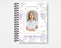 Lilac Whisper memorial guest book template front cover — soft watercolor lilac and pale purple blooms on white, gold arched photo frame, slate script name, IN LOVING MEMORY header, spiral bound — Standard size