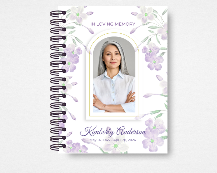 Lilac Whisper memorial guest book template front cover — soft watercolor lilac and pale purple blooms on white, gold arched photo frame, slate script name, IN LOVING MEMORY header, spiral bound — Standard size