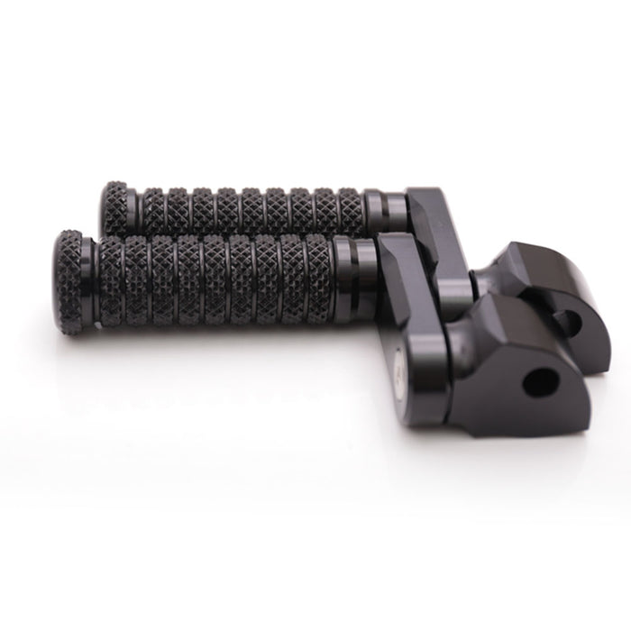 Black 40mm extension rear foot pegs for Aprilia RSV1000 Tuono V4R, by MC Motoparts, shown with mounting hardware on a motorcycle.