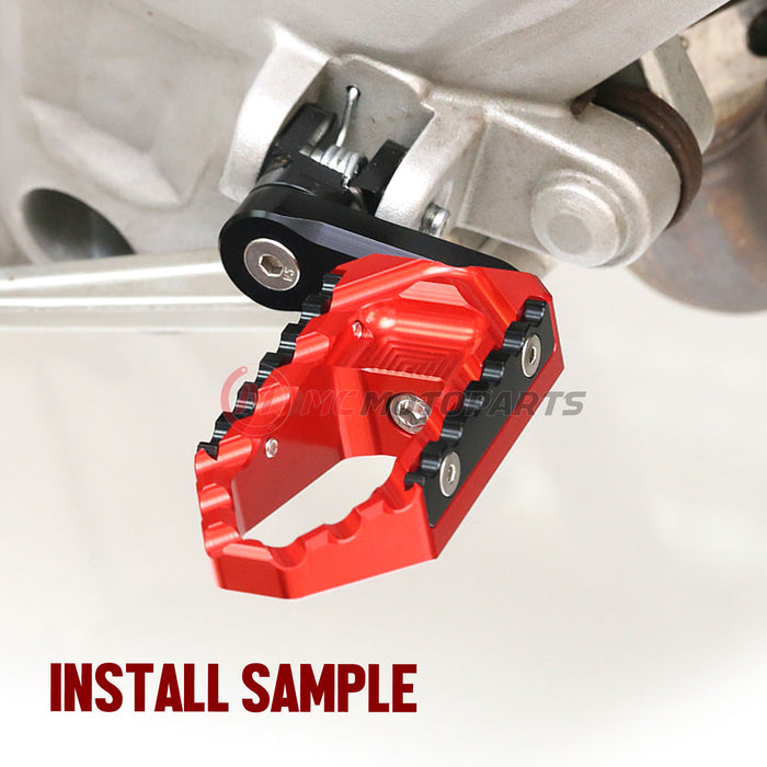 Rear 40mm extension touring wide foot pegs for Honda NC750 NC700 by MC Motoparts, shown installed with black finish.
