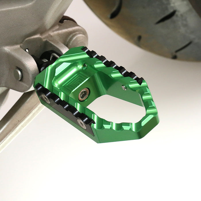 Rear touring wide foot pegs for Kawasaki Z750, Z650, Z1000 by MC Motoparts, shown installed on a motorcycle.