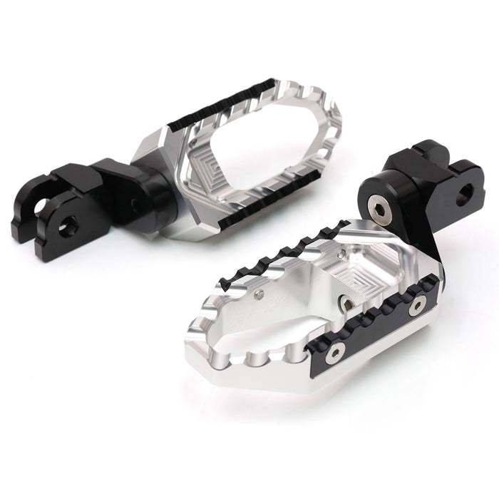 Suzuki SV650 SV1000 rear 25mm extension touring wide foot pegs by MC Motoparts, black metal, mounted on motorcycle footrest brackets.