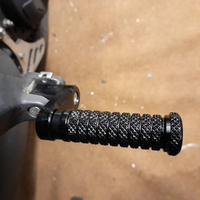 Black 40mm adjustable pole foot pegs for Triumph Speed Four and Speed Triple, by MC Motoparts, mounted on motorcycle.