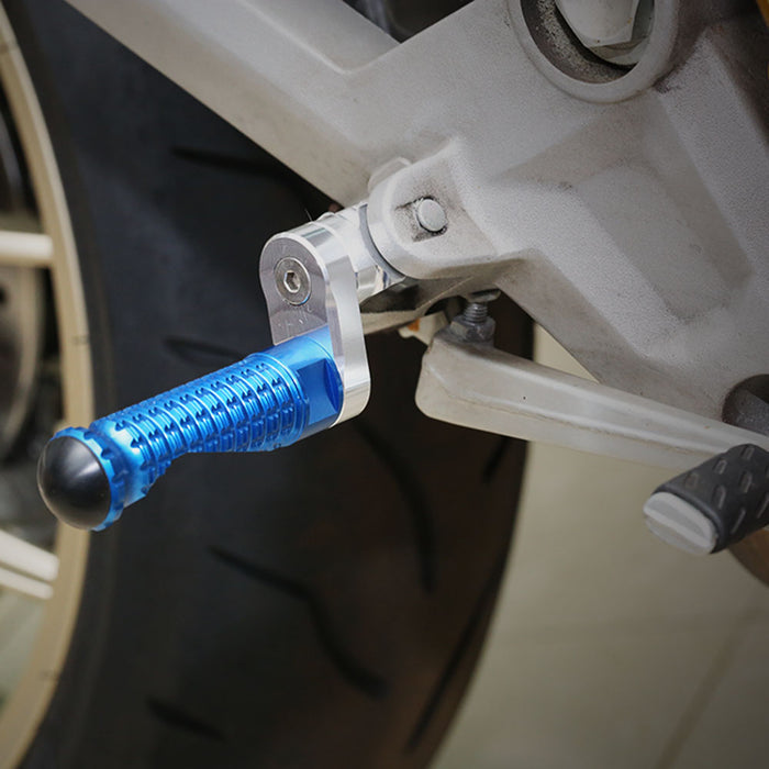 Rear 25mm adjustable extension foot pegs for Yamaha XMAX TMAX 530, made by MC Motoparts, installed on motorcycle footrest.