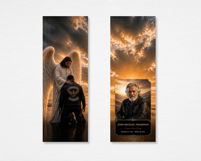 Ride Home memorial bookmark — angel with outstretched wings blessing a kneeling biker in leather jacket against dramatic golden stormy sky on front; rectangular portrait photo, ornate black nameplate, gold script "Forever in Our Hearts," bold name, and dates on back — front and back