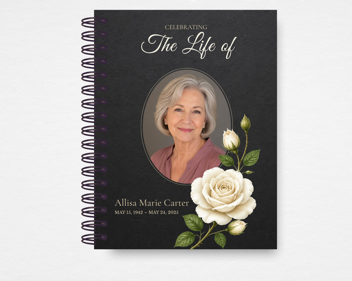 The Bloom That Stays memorial guest book front cover — rich charcoal background with large luminous white roses, ornate filigree corner details, elegant script typography, and a circular portrait photo placeholder; Canva editable