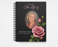 The Bloom That Stays memorial guest book front cover — dark charcoal background with large pink rose and bud, oval photo placeholder, and "Celebrating the Life of" script text — Standard size