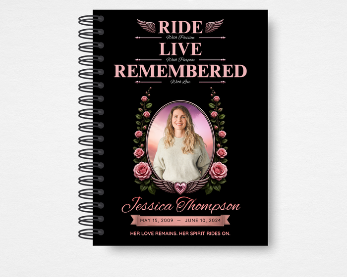 Wild Rose memorial guest book front cover — black background with pink rose bouquet clusters, oval portrait photo placeholder with winged heart emblem, bold pink script name, dates, and "Her Love Remains. Her Spirit Rides On." tagline — Standard size
